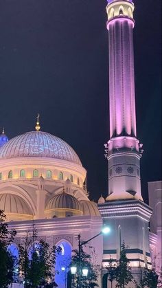 a large white building with a lit up dome