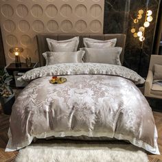 a luxurious bed with white fur rugs and decorative wallpaper in a bedroom setting