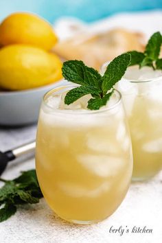 two glasses filled with lemonade and garnished with mint