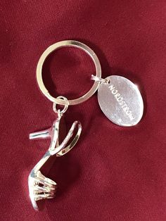 a metal keychain with a silver shoe on it