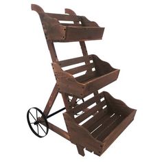 a small wooden cart with wheels on the front and back sides, made out of wood