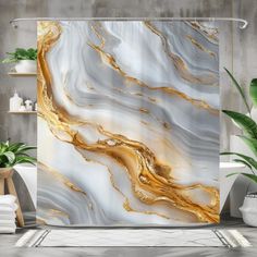 the shower curtain is decorated with gold and white marble