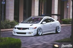 a white car parked in front of a building