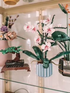 some fake flowers are sitting on a shelf