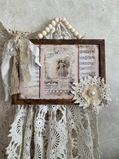 an old photo frame is adorned with lace and pearls