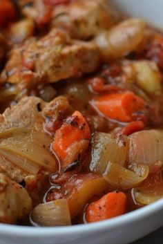 a white bowl filled with meat and vegetables