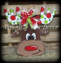 a reindeer head with red and green polka dots on it