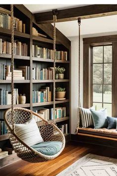 a swing chair in front of a book shelf filled with books