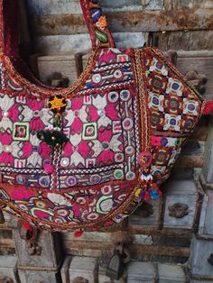 About bag  Indo-gypsy fusion, everyday use hand bag made from Banjara fabrics sourced from Vintage tribal costumes of regions of Rajastan and Gujarat. These are embellished with light catching coins, and intricate bead work tassels. Size - length 15 inches/ width 22 inches Company details:  Company name: Houseoftextile  Contact number: +919784447473  Email id: houseoftextile77@gmail.com  Shipping & custom : Delivery through one of the finest service providers : Skyway, Fedex, UPS  And DHL. Any l Traditional Handmade Multicolor Embroidered Hobo Bag, Traditional Handmade Multicolor Embroidery Hobo Bag, Traditional Multicolor Embroidered Hobo Bag, Traditional Multicolor Embroidered Hobo Shoulder Bag, Handmade Multicolor Embroidered Hobo Bag For Festivals, Handmade Embroidered Hobo Bag For Festivals, Festive Shoulder Bag With Handwork, Bollywood Style Shoulder Bag For Festivals, Traditional Multicolor Embroidered Tote Bag