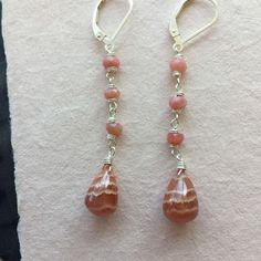 I found some SUPER COOL Rhodocrosite recently and this is one of 3 pairs of these teardrops I purchased. I have wired them with faceted pink opals on sterling silver wire on sterling silver earrings. Please choose your earwire preference as some styles are upgrades from the basic French hook style. The approximate length is 2 1/8". Your jewelry will arrive beautifully giftboxed. Sterling Silver Pink Wire Wrapped Earrings, Pink Sterling Silver Wire Wrapped Earrings, Pink Wire Wrapped Teardrop Earrings, Sterling Silver Natural Stones Teardrop Earrings, Pink Teardrop Earrings With Natural Stones, Sterling Silver Teardrop Earrings With Natural Stones, Stack Earrings, Basic French, Stacked Earrings