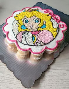 there is a cupcake decorated with an image of princess peach