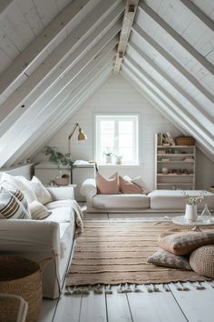 an attic living room with white walls and wooden floors, large rugs on the floor