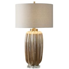 a table lamp with a beige shade on it