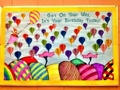 a bulletin board is decorated with balloons and the words get on your way, it's your birthday today