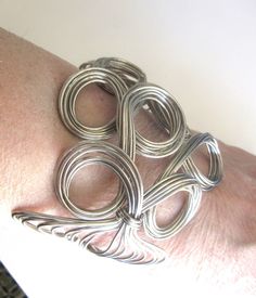 Unique hand crafted ornate open wire work cuff bangle / statement Bracelet in a loop and swirl design.  High at the front 3" inches, sides are 2" inches.  The measurement all the way around is 7.5 inches and the space between the two open ends is 1.5 inches.  Excellent condition. Arm Bangles, Black Bracelets, Vintage Lucite, Statement Bracelet, Swirl Design, Wire Work, Cuff Bangles, Star Pendant, Handmade Artisan