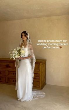 a woman standing in front of a dresser holding a bouquet of flowers