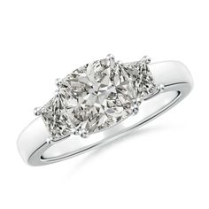 a three stone diamond ring on a white background