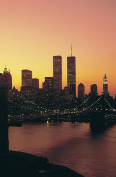 the city skyline is lit up at night