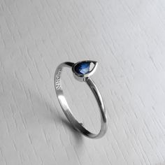 A modern Day Classic White Gold Blue Sapphire Ring. Simple Elegance With a Dash of Splendid. Featuring a pear Shaped 6 x 4 mm Blue Sapphire with a Perfect color and Clarity Approx 0.62 carat. Each Ring is made to Order to your desired ring size and Gold Karat / Color. The Stone sits comfortably inside its own Cup, holding it securely and allowing light from underneath to light up the Gem. The Cup sits about 2.3mm a top the band, Blends well with other stacking rings or with other eternity bands. Modern Blue Birthstone Ring For Gift, Sapphire Teardrop Sterling Silver Ring, Modern Blue Sapphire Ring In Sterling Silver, Teardrop Sapphire Ring In Sterling Silver Gift, Teardrop Sapphire Ring In Sterling Silver, Sapphire Teardrop Ring For Gift, Teardrop Sapphire Birthstone Ring Gift, Blue Pear-shaped Sapphire Ring Gift, Blue Pear-shaped Birthstone Ring