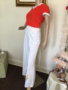 "70's Vintage White High Waist Bell Bottom Pants 70's Vintage White High Waist Bell Bottom Pants White pants with red embroidered lady bug, yellow pink embroidered flowers at bottom of pant legs, Hi rise waist with front/back darts, wide leg bell bottoms, and back button/zip closure. Listing for pants only. Good vintage condition. Has small stains at bottom of pant leg, and two at waist, (see pics). Tag Size: 11 Measurements: Waist: 26\" Rise: 13\" Hips: 36\" Inseam: 31 1/2\" Length: 43 1/2\" Leg Width: 12 1/2 seam to seam" Retro Wide Leg Full Length Pants For Spring, Retro Wide Leg Pants For Spring, White Cotton Retro Bottoms, Vintage Full Length Bottoms For Spring, Retro Stretch Wide Leg Pants For Spring, Spring Retro Stretch Wide Leg Pants, Fitted Cotton Pants For Spring, Fitted Wide Leg Cotton Pants For Summer, Retro High-waisted Cotton Wide Leg Pants