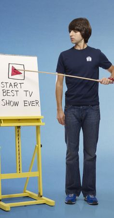 a man standing next to a sign that says start best tv show ever