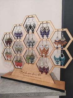 a display case with many pairs of earrings on it