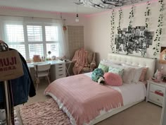 a bed room with a neatly made bed next to a window and a desk in front of it