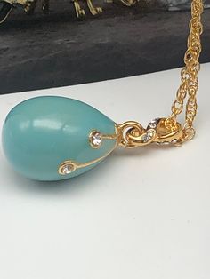 This egg pendant is a great gift for a loved one or for yourself. It is such a unique present it is made for art lovers who get inspired by beautiful things. This beautiful pendant will add charm to every outfit! Item Size: Centimeters : 1.5 x 1.5 x 2.5 Inches : 0.59 x 0.59 x 0.98 Total Length (with the chain): Centimeters: 44 Inches: 17.32 Catalog #: P720 * Each crystal is handpicked and artistically placed on the piece * Plated with 24K gold * The item is shipped in an elegant black bag. * The Turquoise Oval Enamel Jewelry, Oval Turquoise Enamel Jewelry, Oval Enamel Necklace For Gift, Turquoise Oval Pendant Jewelry Gift, Turquoise Oval Pendant Jewelry As Gift, Turquoise Oval Pendant Jewelry For Gift, Oval Pendant Enamel Necklace For Gift, Enamel Oval Pendant Necklace For A Gift, Turquoise Teardrop Pendant Jewelry As Gift