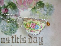 a close up of a necklace with flowers on it and the words, mother's day