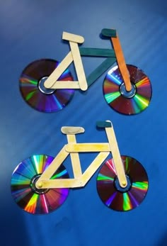 there are two pieces of wood that have been made to look like bicycles on cds