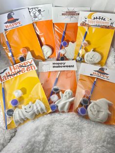 six halloween themed toothbrushes in plastic bags on a white furnishing surface