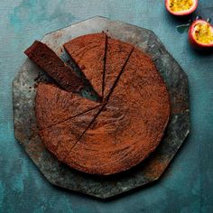 a chocolate cake on a plate with two pieces cut out