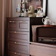 there is a dresser with many items on it