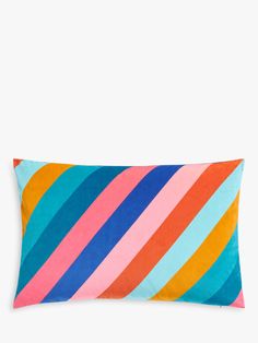 a colorful striped pillow on a white background