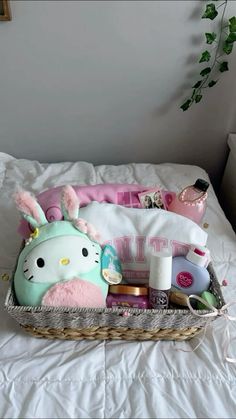 a hello kitty gift basket sitting on top of a bed