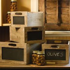 several wooden boxes with chalkboard labels on them