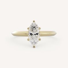 an oval cut diamond ring with three clawed shoulders