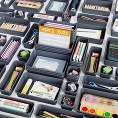 an assortment of office supplies are arranged on a table top with labels and pencils