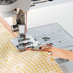 someone using a sewing machine to sew fabric