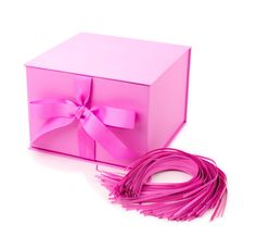 a pink gift box with ribbon and bow on the top, next to it's contents