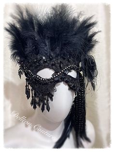 Handmade Black velvet and feather, sequin lace and beads, stones, etc. Very comfortable to wear. Perfect for that masquerade, or for that someone who wants to be a little bit different. The back has velvet covered elastic for extra security. This mask is soft and is lined in soft black velvet. With a detachable fabric rose with feather tassels and beads. You could even put it on your wall. Dellton as seen on BBC1 and Sky 1 Any questions please contact me  Thanks Sally xx Please allow extra time Gothic Masquerade, Venetian Masquerade Ball, Masquerade Mask Black, Gothic Mask, Lace And Beads, Venetian Masquerade, Fabric Rose, Mask Black, Fabric Roses