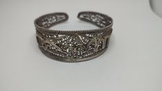 Beautiful antique bracelet made by sterling silver worked in filigree tehnique, no hallmarks, been tested with acid for silver,with time patina In great condition Weight 30grams All of our pieces are in pre-loved, vintage or antique condition, with signs of age and wear preserved as a mark of authenticity. Antique Hallmarked Cuff Bracelet For Gift, Ornate Engraved Cuff Bracelet, Ornate Bangle Cuff Bracelet With Intricate Design, Ornate Hallmarked Cuff Bracelet For Ceremonial Use, Ornate Hallmarked Cuff Bracelet For Ceremonial Occasions, Ornate Ceremonial Cuff Bracelet Hallmarked, Antique Sterling Silver Bangle With Intricate Design, Ornate Ceremonial Cuff Bracelet With Hallmark, Traditional Filigree Cuff Bracelet Bangle