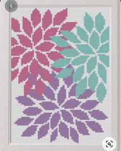 a cross stitch pattern with pink, blue and green flowers in the shape of leaves