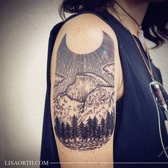 a man's arm with a mountain and trees tattoo on the upper half of his arm