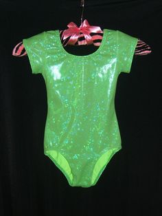 a neon green bodysuit hanging on a clothes line with a pink bow at the top