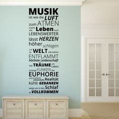 a room with a large wall decal that has words written in different languages on it