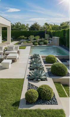 an outdoor garden with grass and plants next to a swimming pool in the middle of it