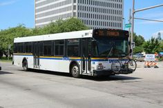 a city bus is parked on the side of the road with its bike rack attached to it