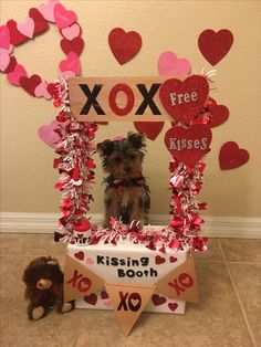 a small dog sitting in front of a valentine's day photo frame