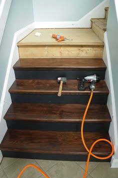 a set of stairs with an orange cord attached to it